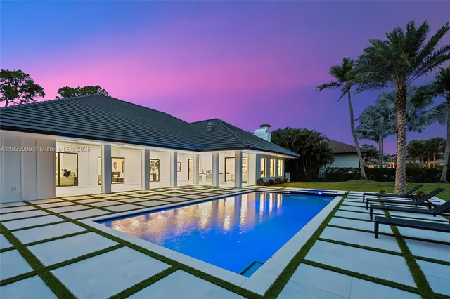 an aerial view of a house with a lake view