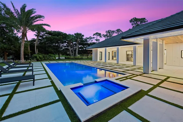 a front view of a house with a yard table and chairs