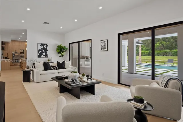 a kitchen with stainless steel appliances granite countertop a sink a stove and a wooden floors
