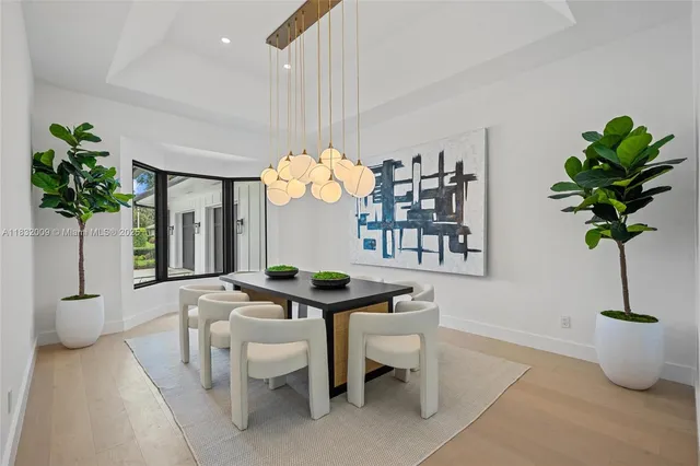 a kitchen with stainless steel appliances a stove a sink a chimney a dining table and chairs