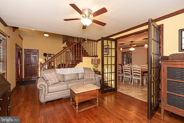 a living room with furniture a flat screen tv and a large window