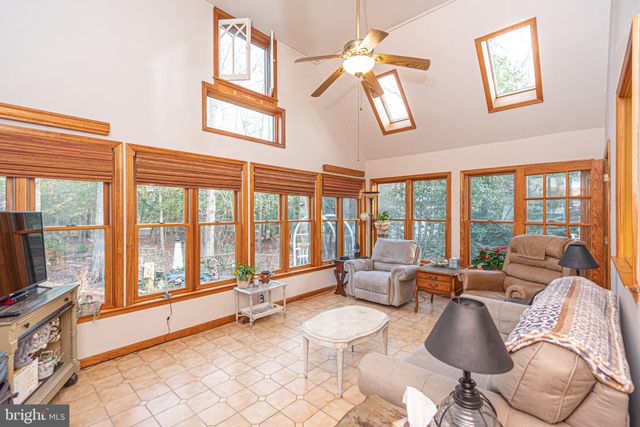 a kitchen with stainless steel appliances a sink a stove a refrigerator cabinets and a window