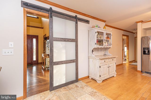 a kitchen with stainless steel appliances a stove a refrigerator and cabinets
