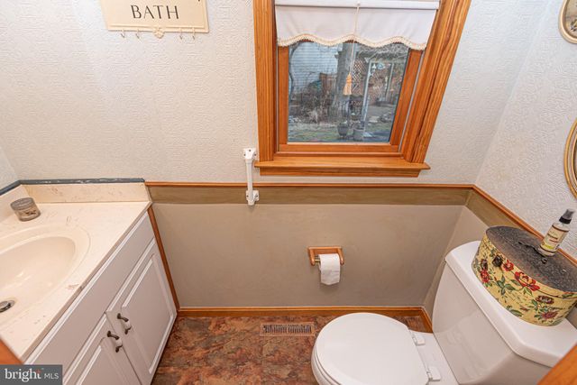 a bedroom with a bed and ceiling fan