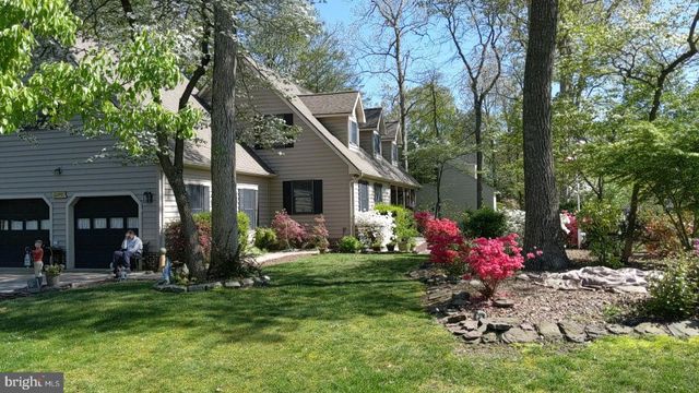 front view of house with a yard and potted plants