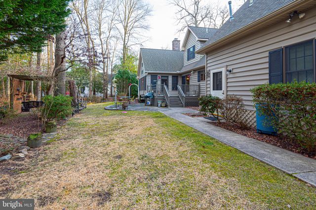 a view of a green field with wooden fence