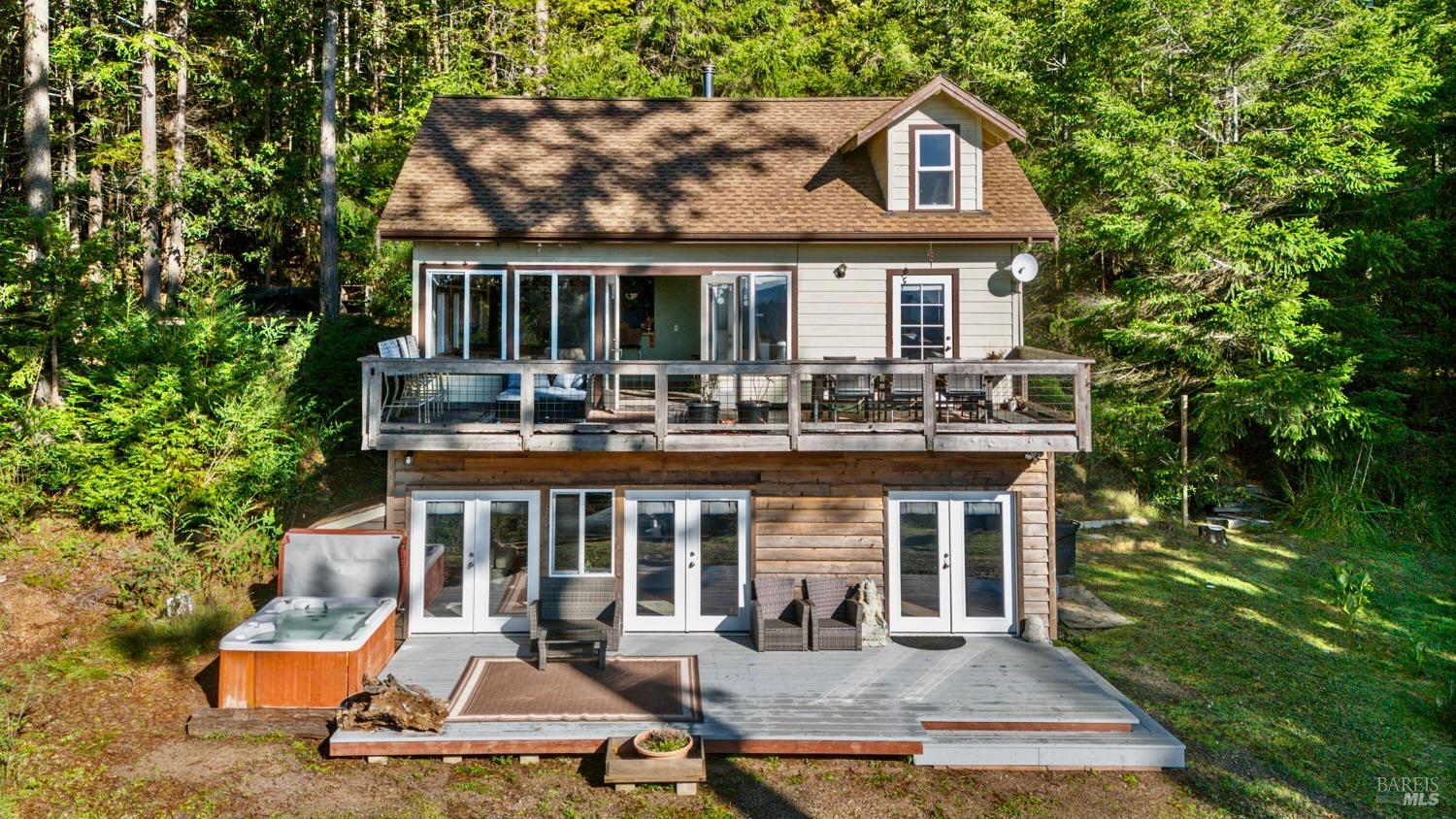 a front view of a house with swimming pool and sitting area