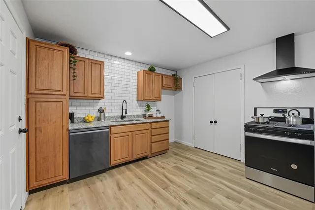 a kitchen with stainless steel appliances granite countertop a stove and a refrigerator