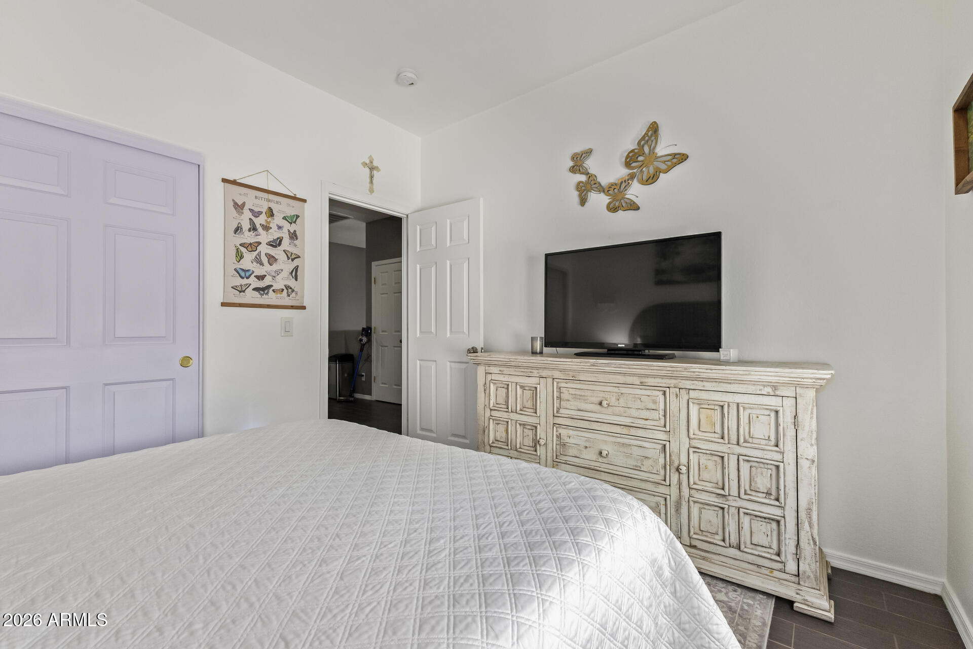 2600 East Springfield Place, Unit 34 Chandler, AZ 85286 - Photo 18 of 38 a bedroom with a bed and a flat screen tv