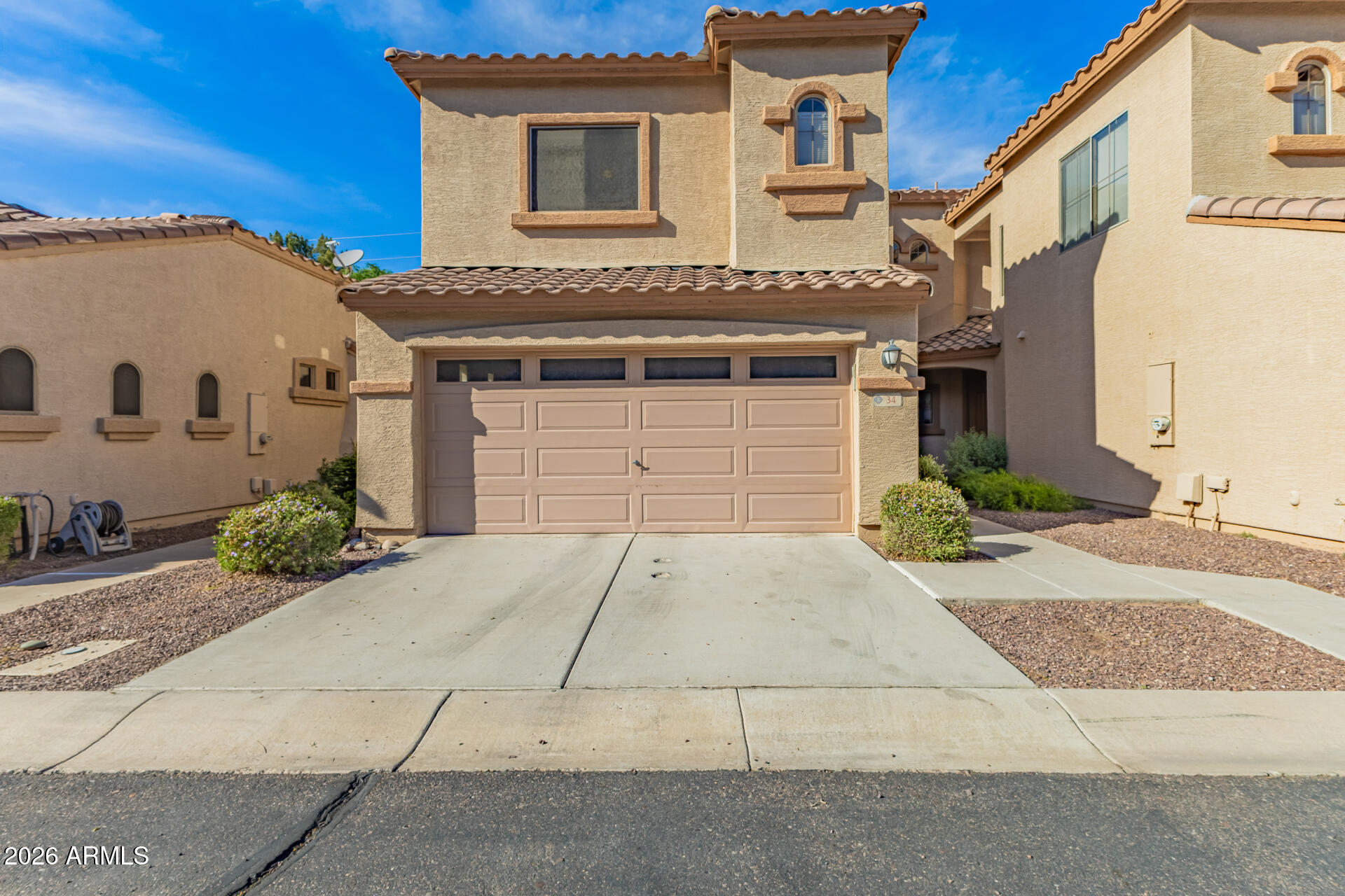 2600 East Springfield Place, Unit 34 Chandler, AZ 85286 - Photo 24 of 38 a front view of a house with a yard