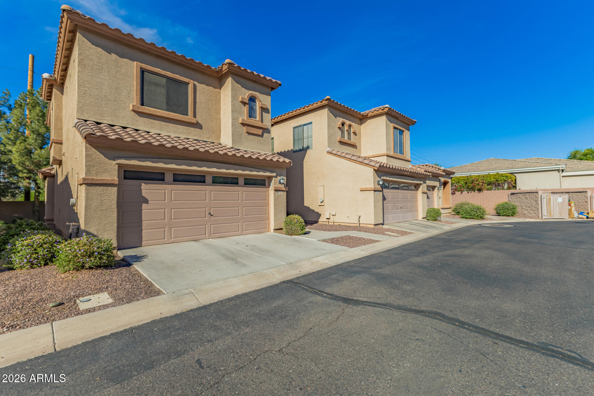 2600 East Springfield Place, Unit 34 Chandler, AZ 85286 - Photo 26 of 38 a front view of a house with a yard and garage