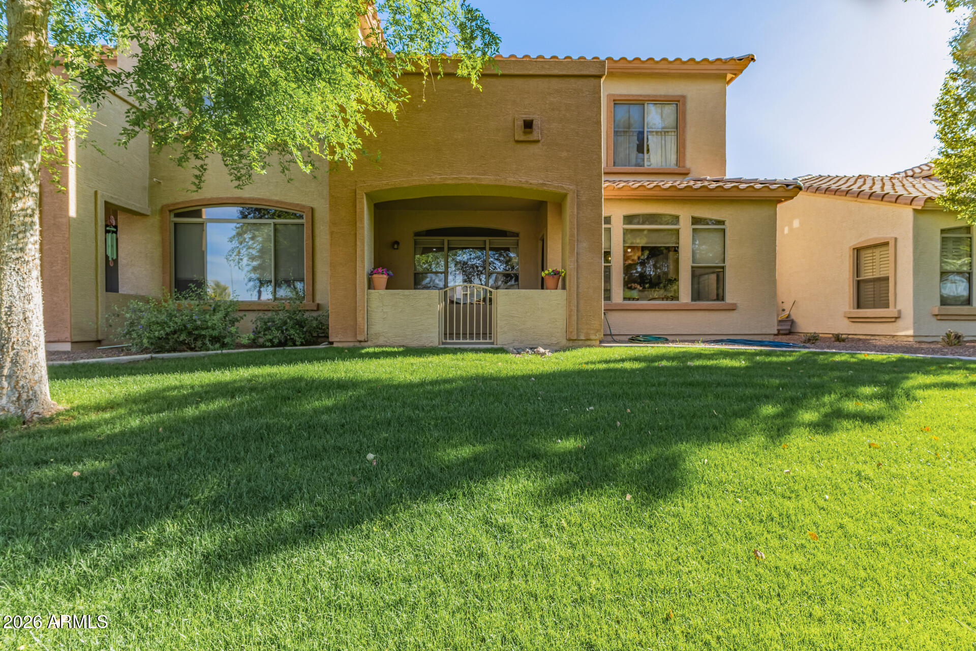 2600 East Springfield Place, Unit 34 Chandler, AZ 85286 - Photo 29 of 38 a large tree in front of a house with a yard
