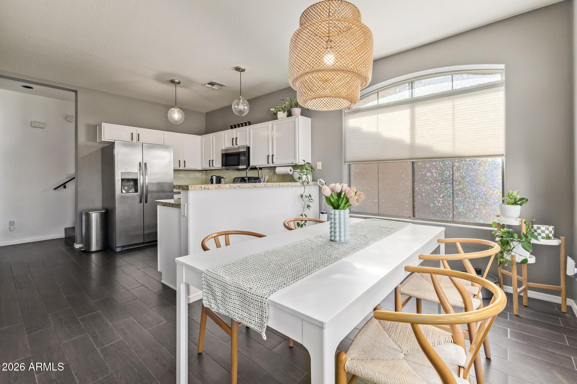 2600 East Springfield Place, Unit 34 Chandler, AZ 85286 - Photo 5 of 38 a kitchen with stainless steel appliances a table chairs and wooden floor