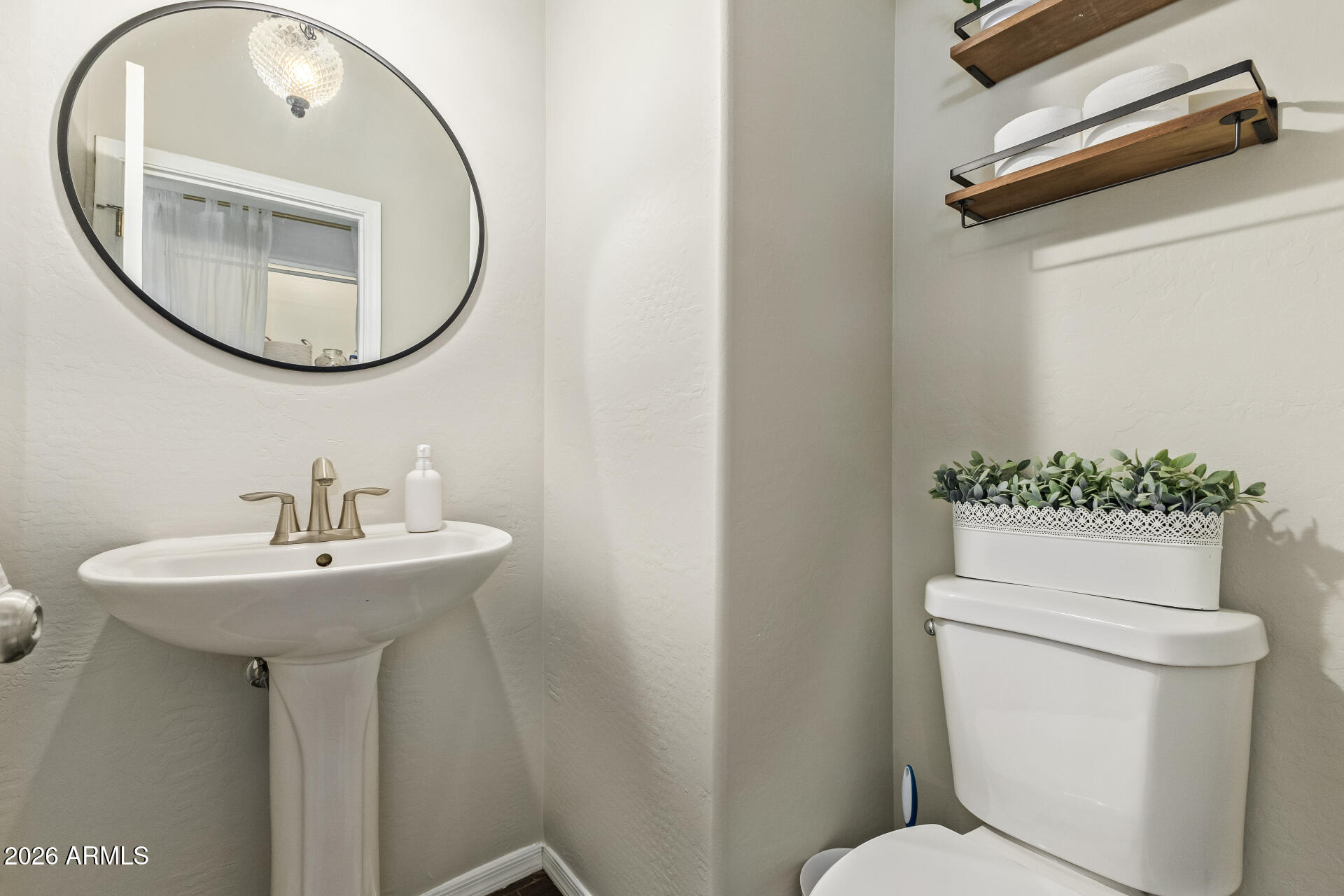 2600 East Springfield Place, Unit 34 Chandler, AZ 85286 - Photo 8 of 38 a bathroom with a toilet a sink and a mirror