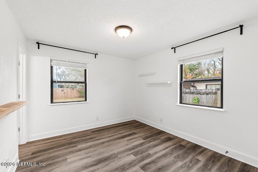 6731 Sans Souci Road Jacksonville, FL 32216 - Photo 13 of 27 a view of an empty room with wooden floor and window