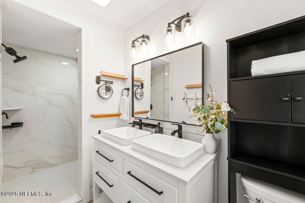 6731 Sans Souci Road Jacksonville, FL 32216 - Photo 15 of 27 a bathroom with a sink and a mirror