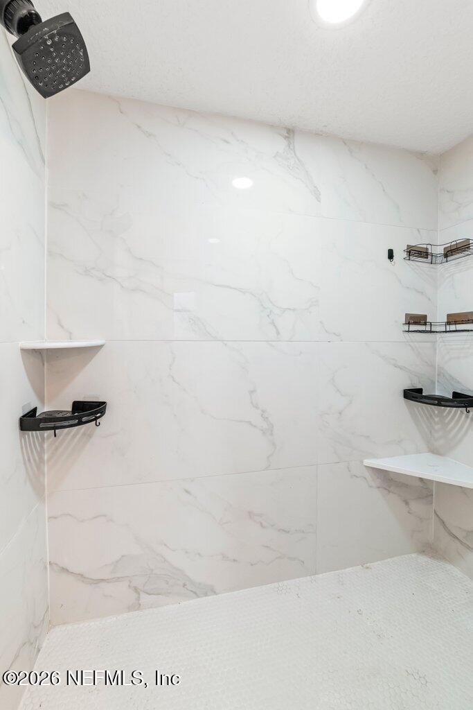 6731 Sans Souci Road Jacksonville, FL 32216 - Photo 16 of 27 a bathroom with a bathtub and a shower