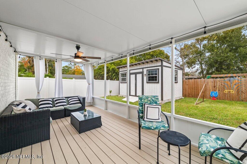 6731 Sans Souci Road Jacksonville, FL 32216 - Photo 20 of 27 a view of a patio with table and chairs potted plants with wooden floor