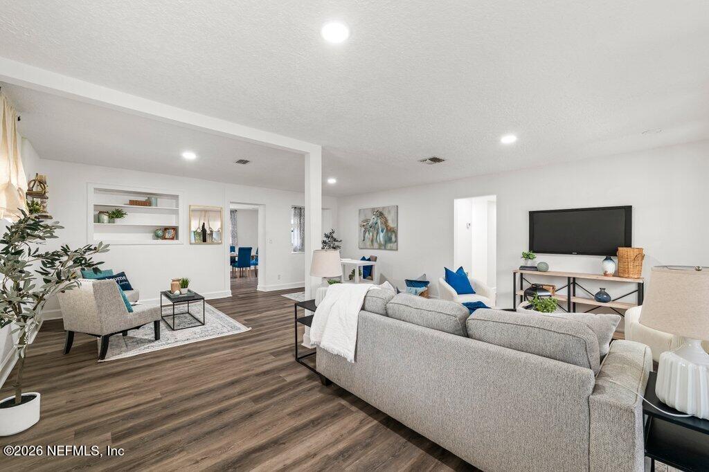 6731 Sans Souci Road Jacksonville, FL 32216 - Photo 2 of 27 a living room with furniture and a flat screen tv