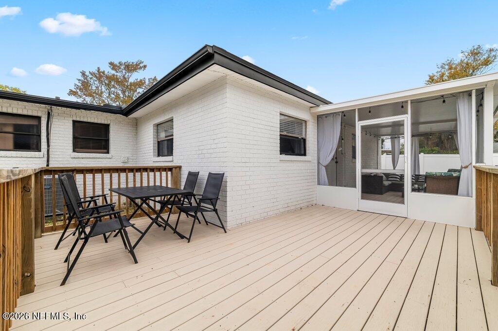 6731 Sans Souci Road Jacksonville, FL 32216 - Photo 21 of 27 a view of a house with wooden deck and furniture