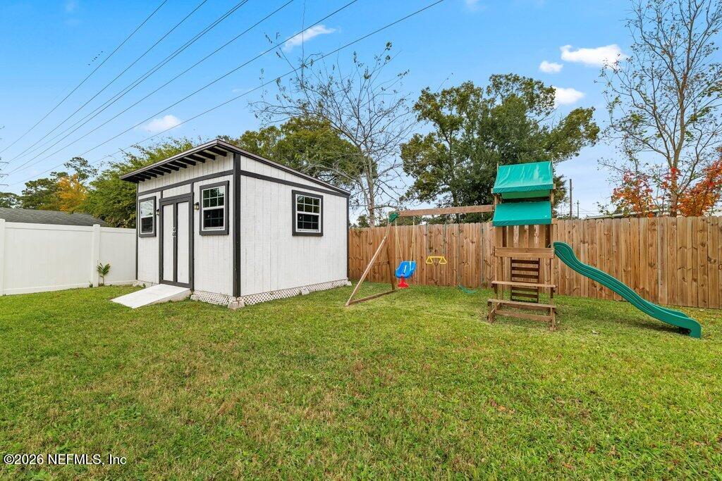 6731 Sans Souci Road Jacksonville, FL 32216 - Photo 23 of 27 a white house with a big yard and large tree