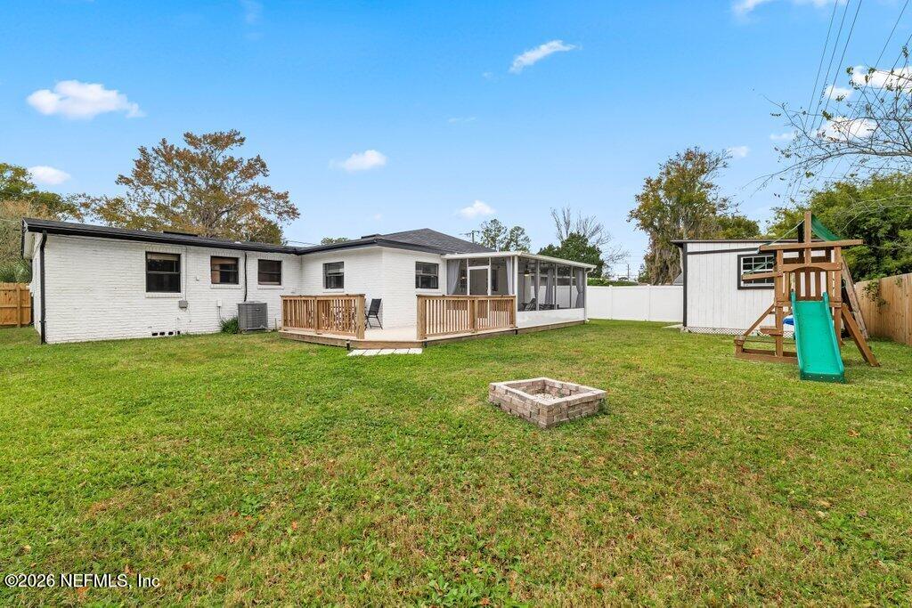 6731 Sans Souci Road Jacksonville, FL 32216 - Photo 24 of 27 a front view of a house with a yard table and chairs
