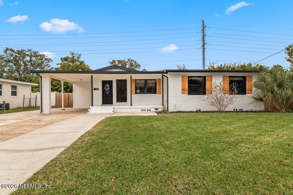 6731 Sans Souci Road Jacksonville, FL 32216 - Photo 26 of 27 a front view of a house with yard