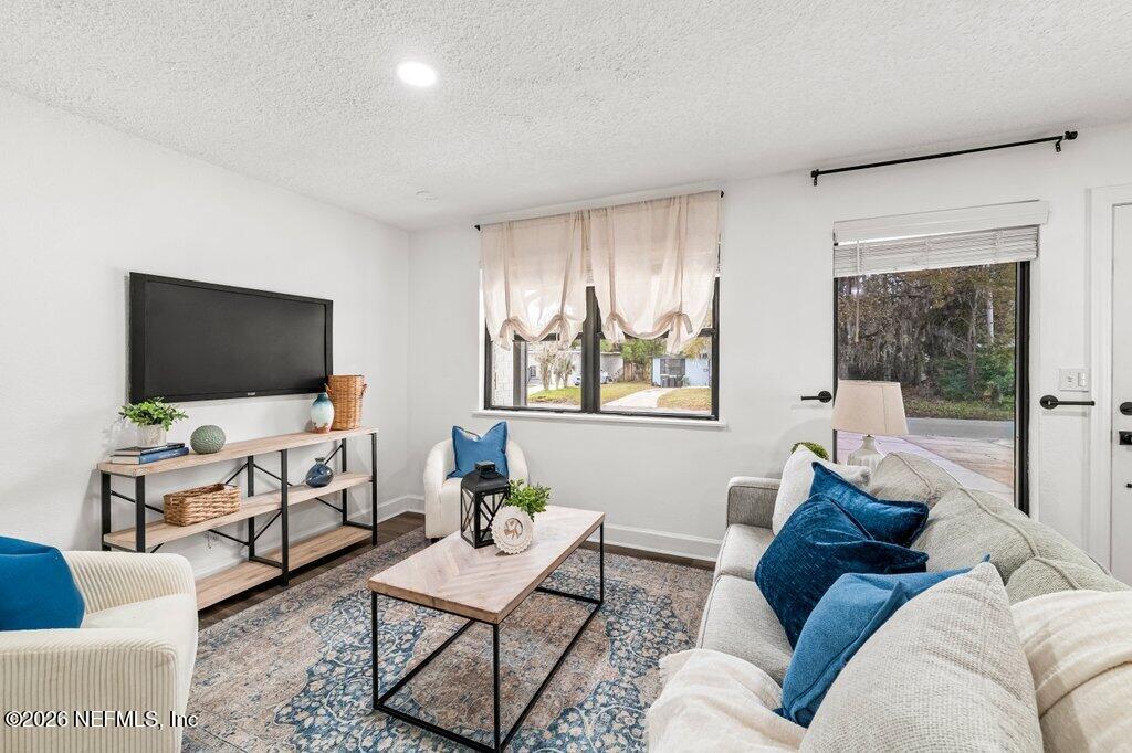 6731 Sans Souci Road Jacksonville, FL 32216 - Photo 4 of 27 a living room with furniture and a flat screen tv