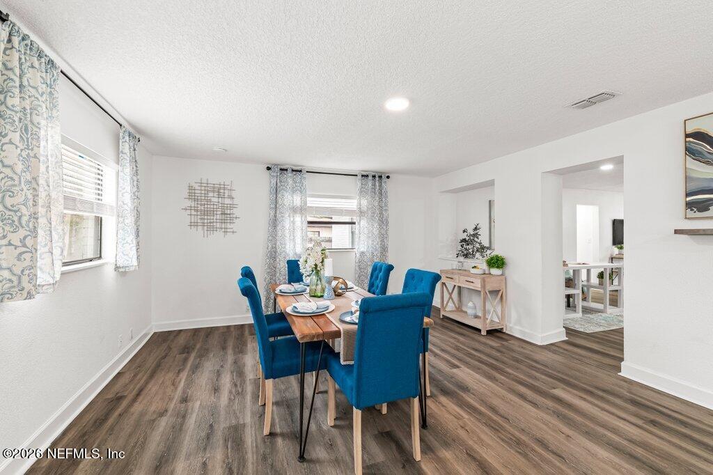 6731 Sans Souci Road Jacksonville, FL 32216 - Photo 6 of 27 a view of a dining room with furniture and wooden floor