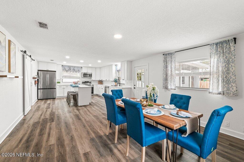 6731 Sans Souci Road Jacksonville, FL 32216 - Photo 7 of 27 a living room with furniture a dining table and kitchen view