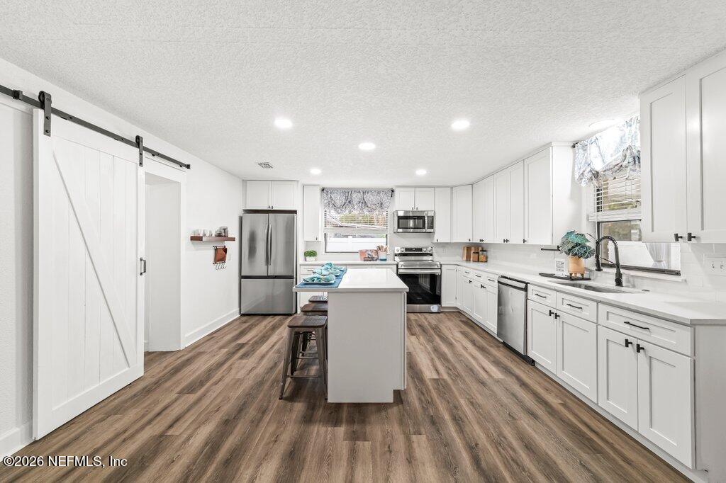 6731 Sans Souci Road Jacksonville, FL 32216 - Photo 8 of 27 a kitchen with a sink stainless steel appliances cabinets and a counter top space