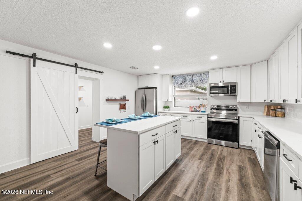 6731 Sans Souci Road Jacksonville, FL 32216 - Photo 9 of 27 a kitchen with a sink a counter top space stainless steel appliances and a cabinets