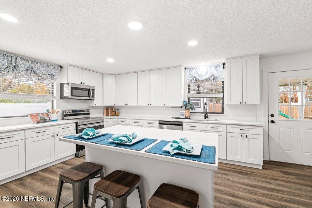 6731 Sans Souci Road Jacksonville, FL 32216 - Photo 10 of 27 a kitchen with white cabinets and appliances