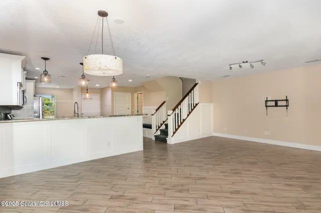 a view of entryway and hall with a wooden floor