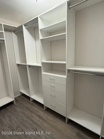 a view of walk in closet with empty racks