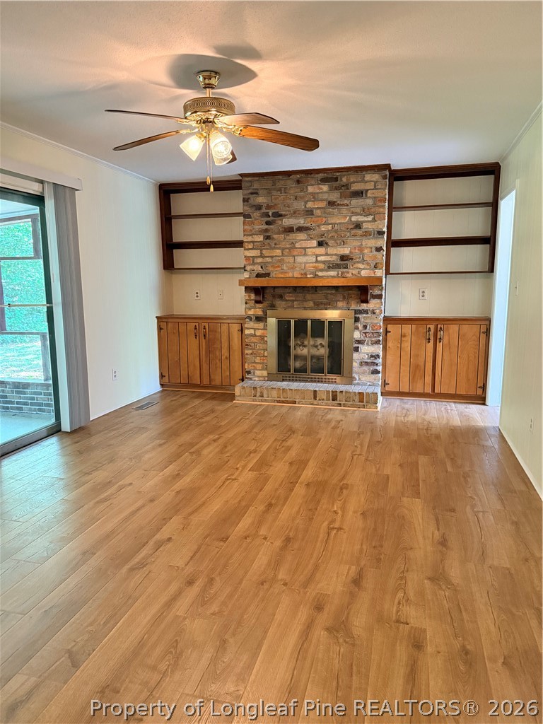 425 Dunmore Road Fayetteville, NC 28303 - Photo 11 of 21 a living room with a fireplace furniture and a ceiling fan