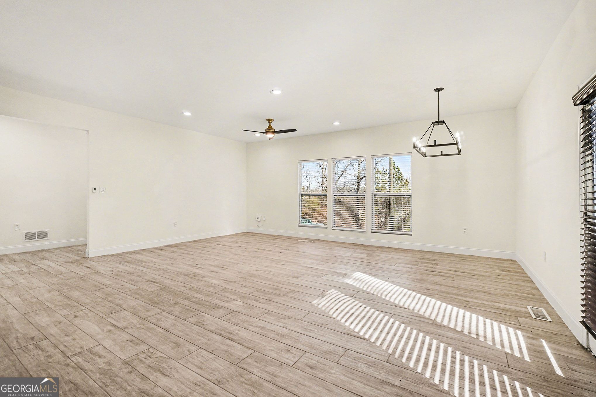 1480 Norris Place Northwest Atlanta, GA 30314 - Photo 13 of 30 a view of an empty room with wooden floor and a window