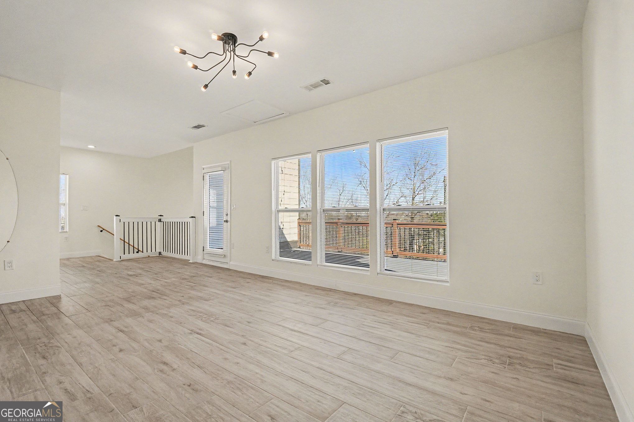1480 Norris Place Northwest Atlanta, GA 30314 - Photo 19 of 30 a view of an empty room with a window and wooden floor