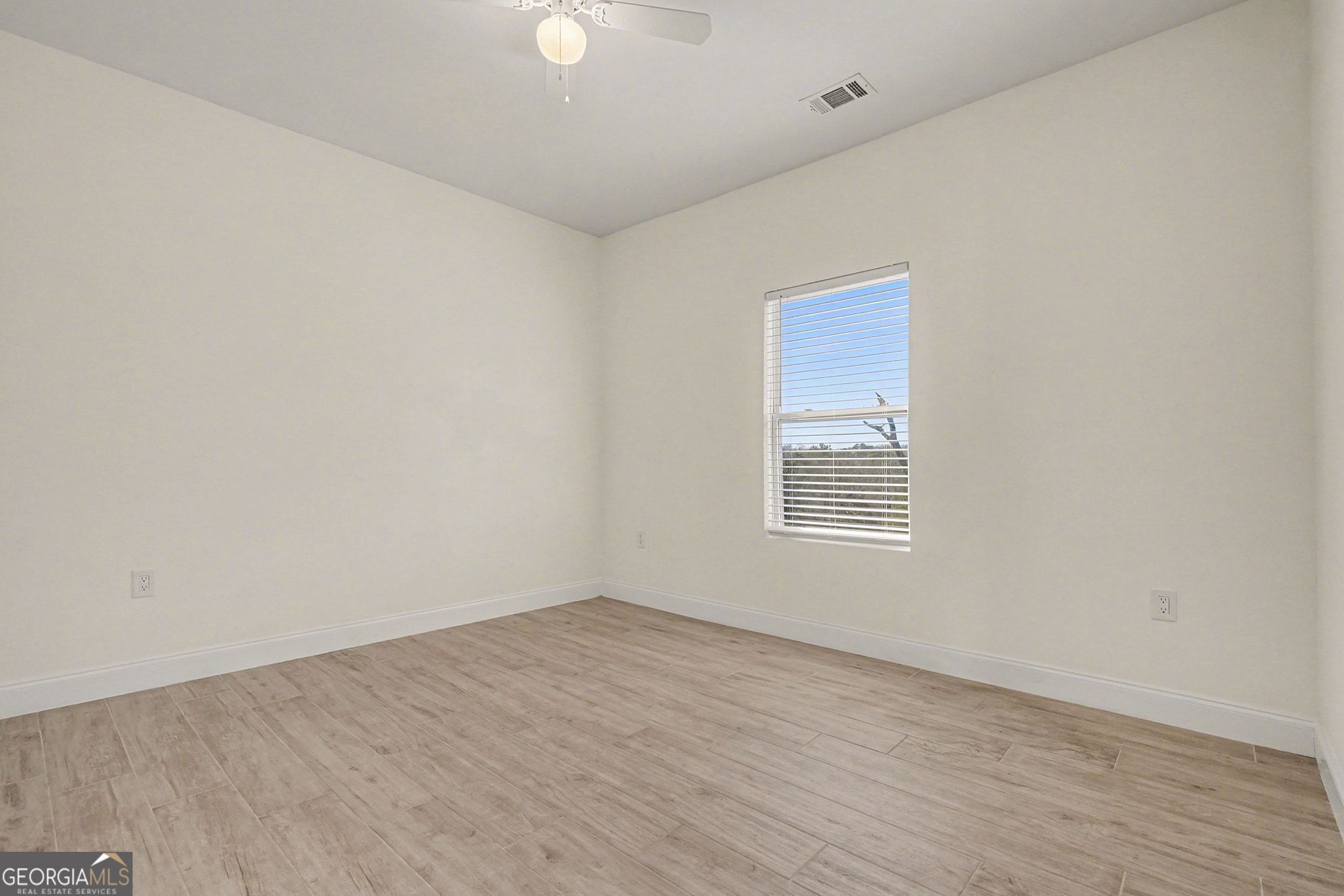 1480 Norris Place Northwest Atlanta, GA 30314 - Photo 21 of 30 a view of an empty room with wooden floor and a window