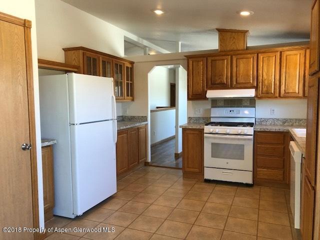 414 East 7th Street Rifle, CO 81650 - Photo 3 of 20 a kitchen with a refrigerator sink and cabinets