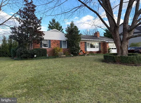 a front view of house with yard and trees