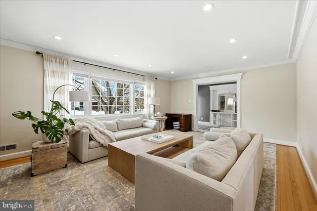 a living room with patio furniture and a flat screen tv
