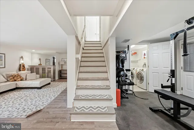 a living room with furniture and view of kitchen