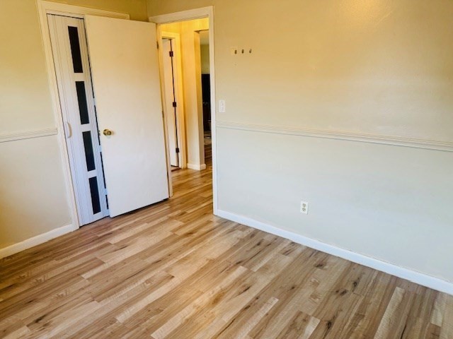 85 Ridgewood Lane, Unit 18 Gardner, MA 01440 - Photo 7 of 13 an empty room with wooden floor and a window