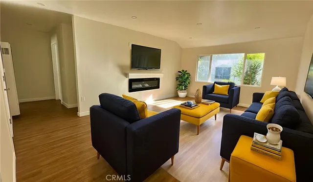 a living room with furniture a fireplace and a flat screen tv