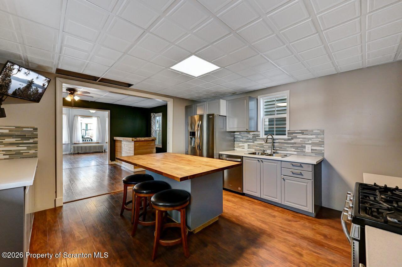 328 Ferdinand Street Scranton, PA 18508 - Photo 15 of 40 a kitchen with stainless steel appliances granite countertop a stove refrigerator and a sink