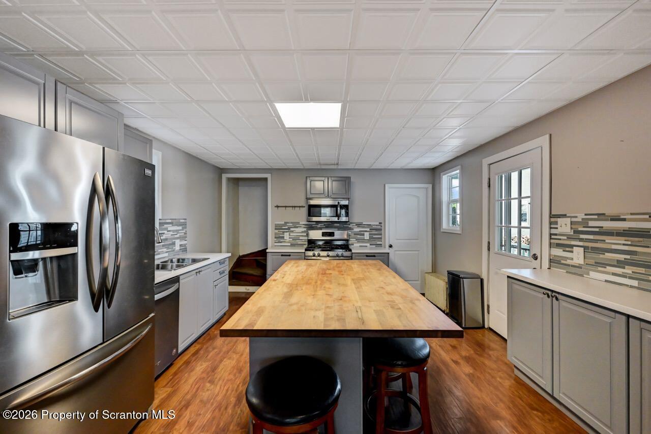 328 Ferdinand Street Scranton, PA 18508 - Photo 16 of 40 a kitchen with stainless steel appliances a dining table chairs stove and refrigerator