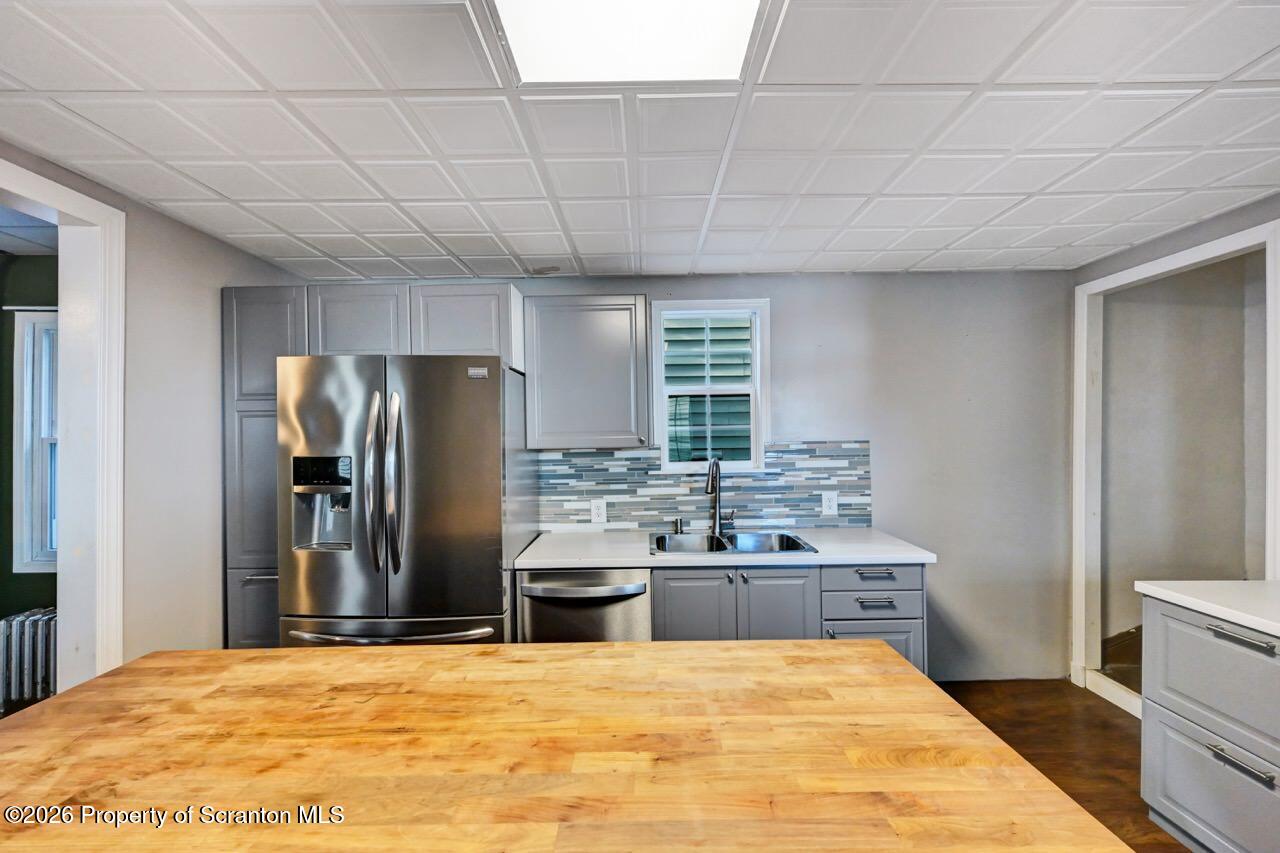 328 Ferdinand Street Scranton, PA 18508 - Photo 18 of 40 a large kitchen with stainless steel appliances a large counter top a stove a refrigerator and a sink