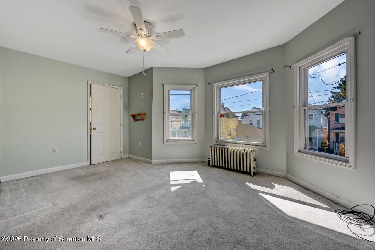 328 Ferdinand Street Scranton, PA 18508 - Photo 25 of 40 a view of livingroom with window chandelier fan and windows