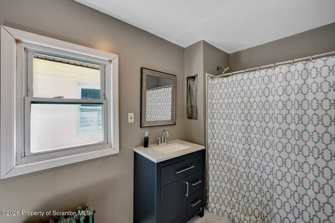 328 Ferdinand Street Scranton, PA 18508 - Photo 31 of 40 a bathroom with a sink and a mirror